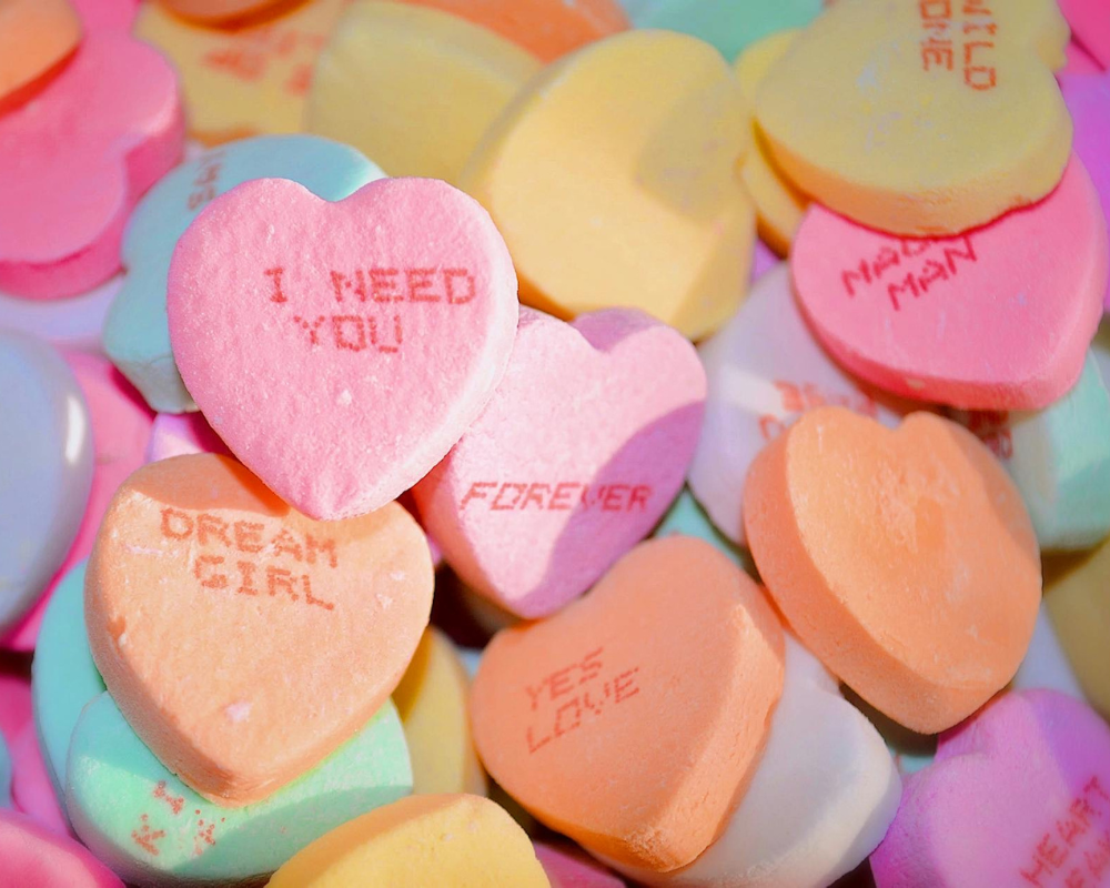 Pastel colored small candy hearts with love messages
