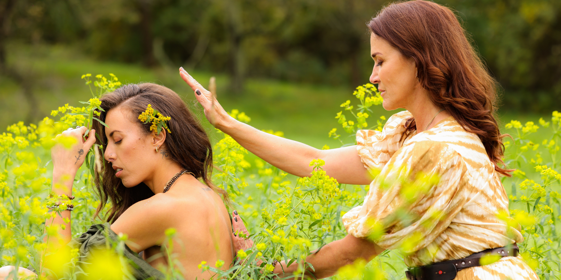 Maria Marshall giving Reiki to a woman in a field